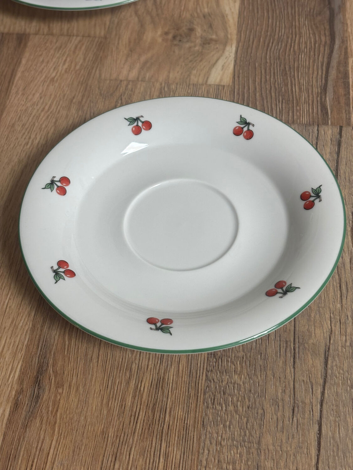 Set of 4 large cherry porcelain cups and saucers.