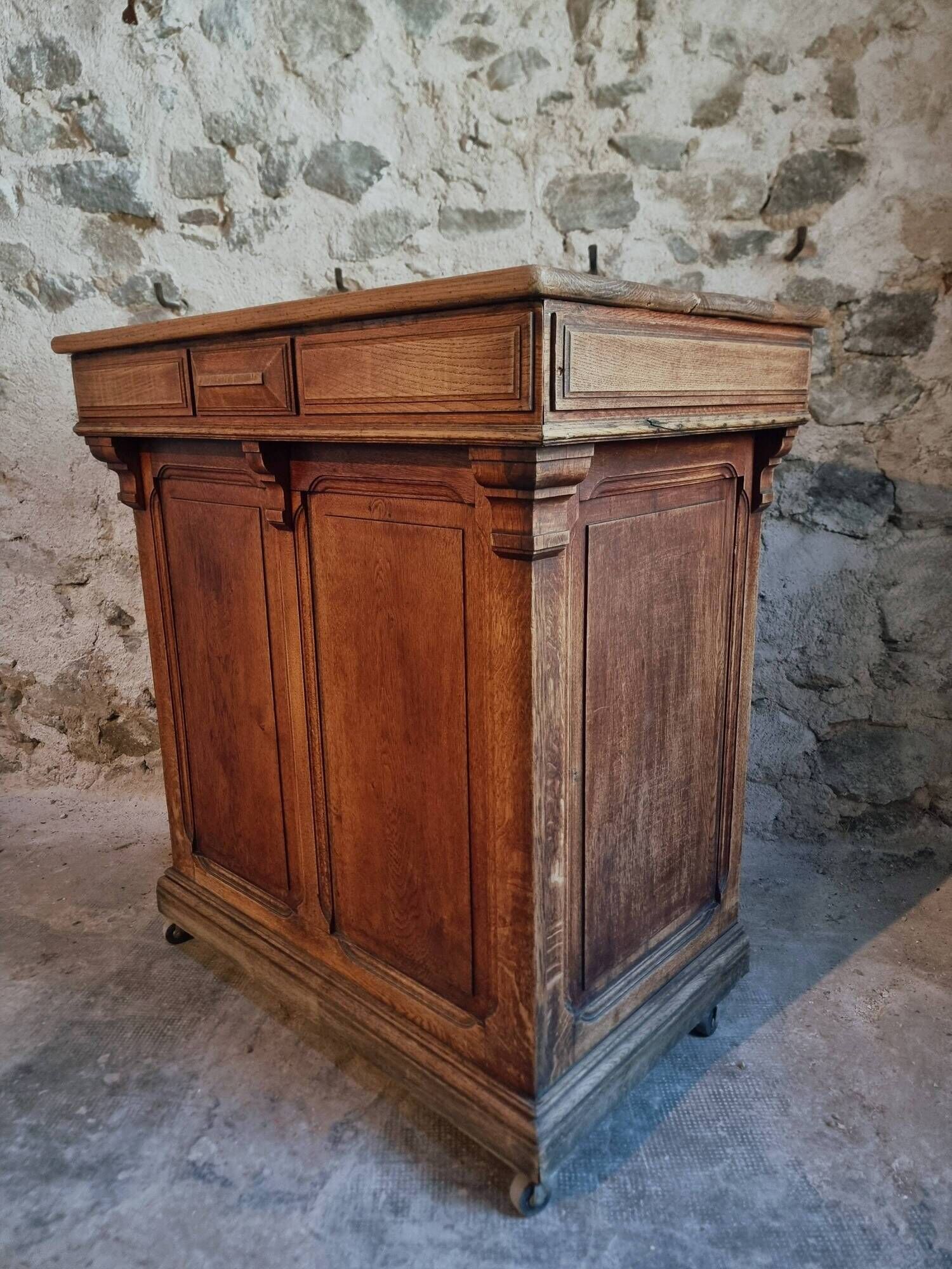 Antique French oak shop counter, kitchen island on wheels, circa 1880–1900.