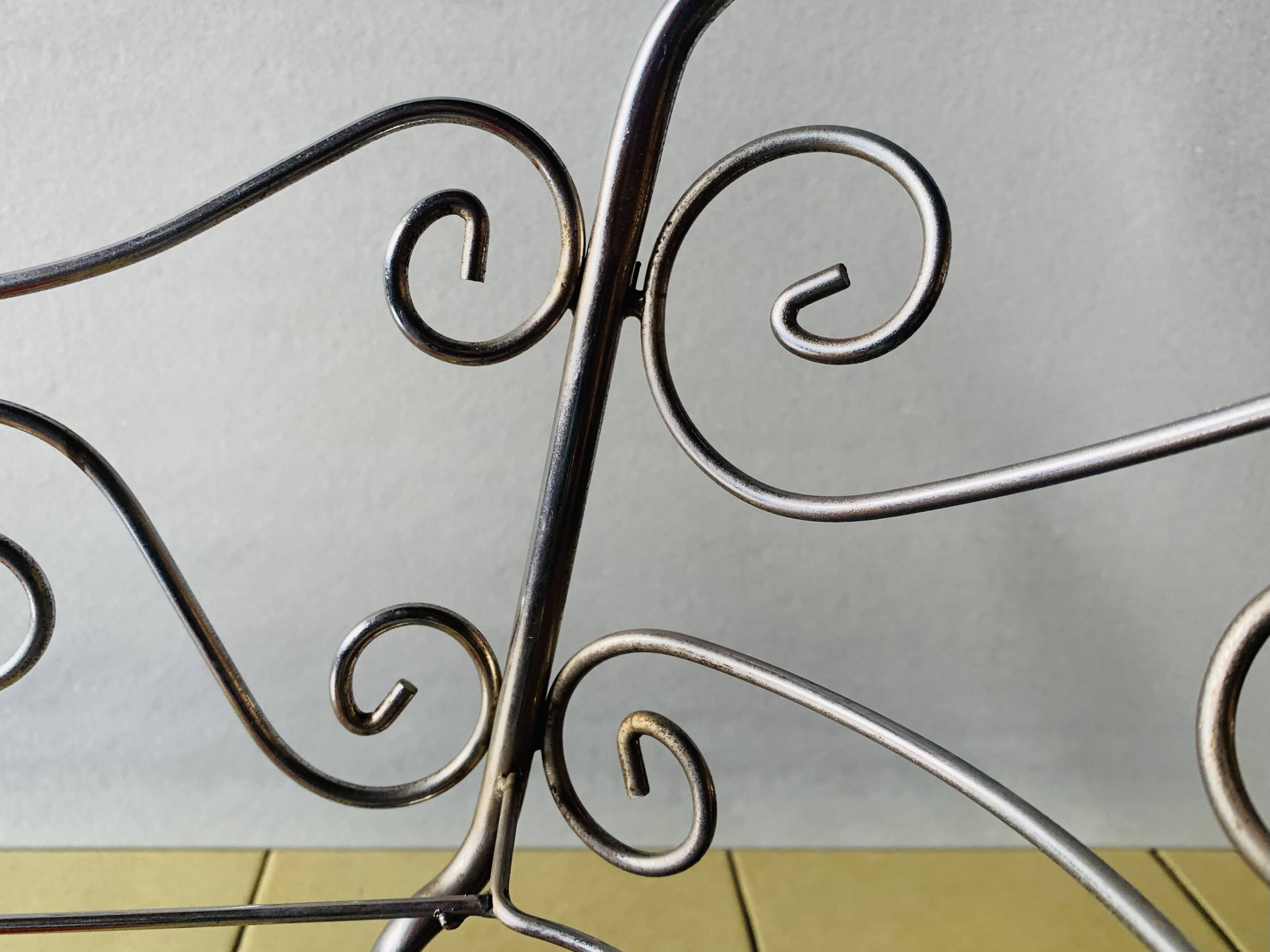 Metal doll's bed on vintage casters