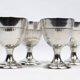 Four silver-plated Christofle egg cups with fluted sides.