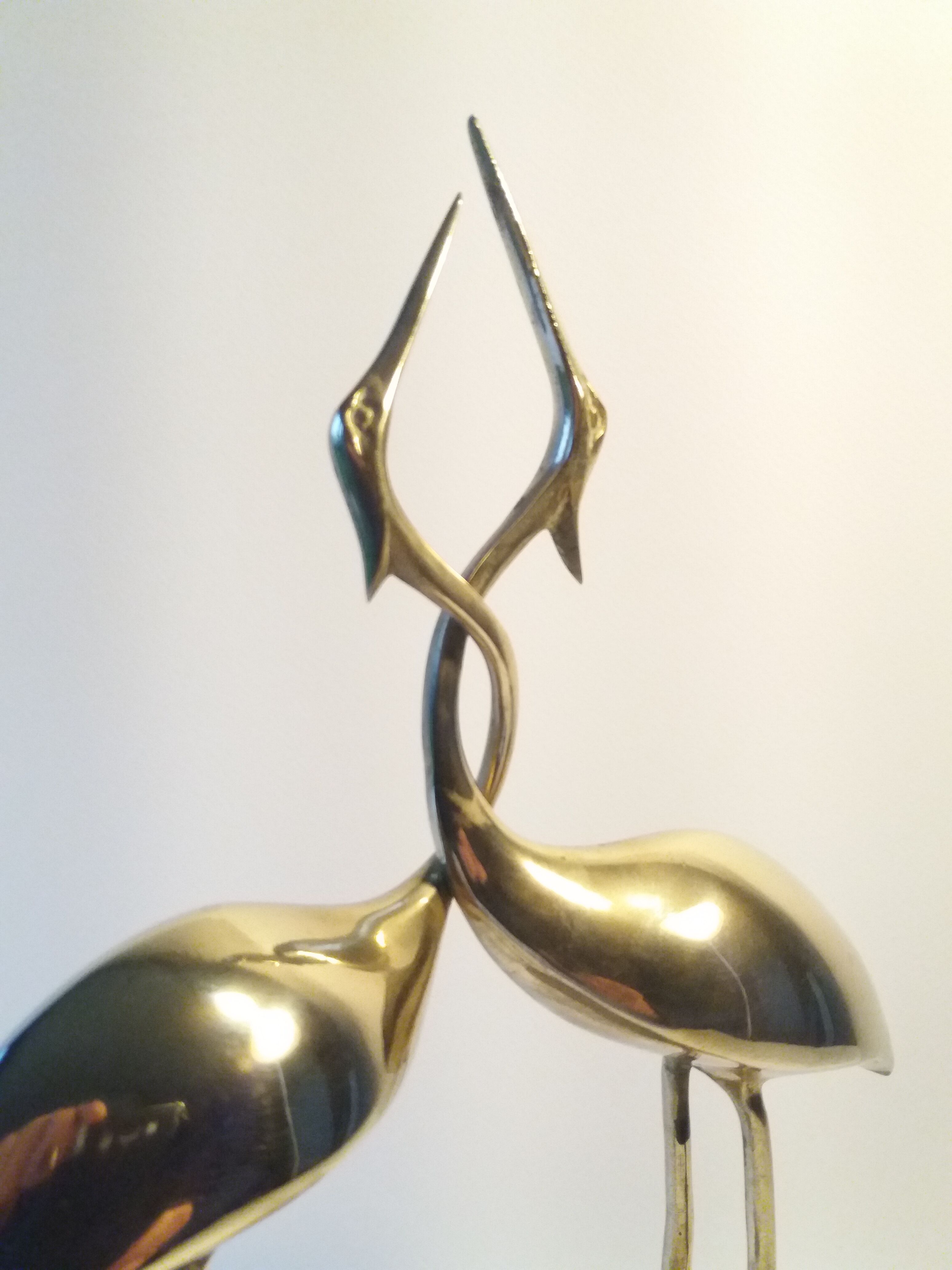 Herons entwined brass