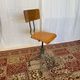 Old high workshop chair made of wood and metal.