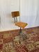 Old high workshop chair made of wood and metal.