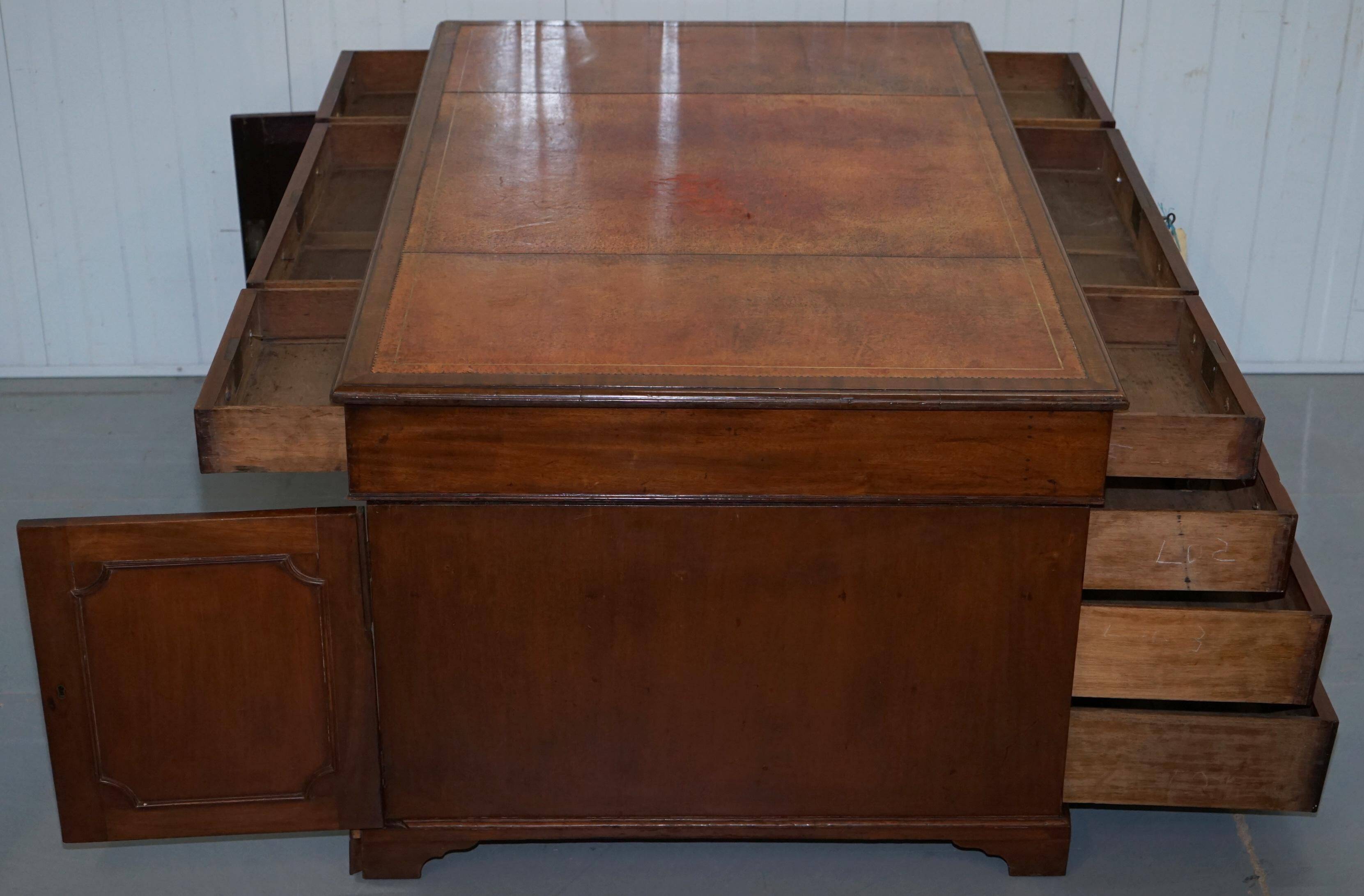 Double-sided partner's desk in walnut, George III, circa 1780, with lion head handles.