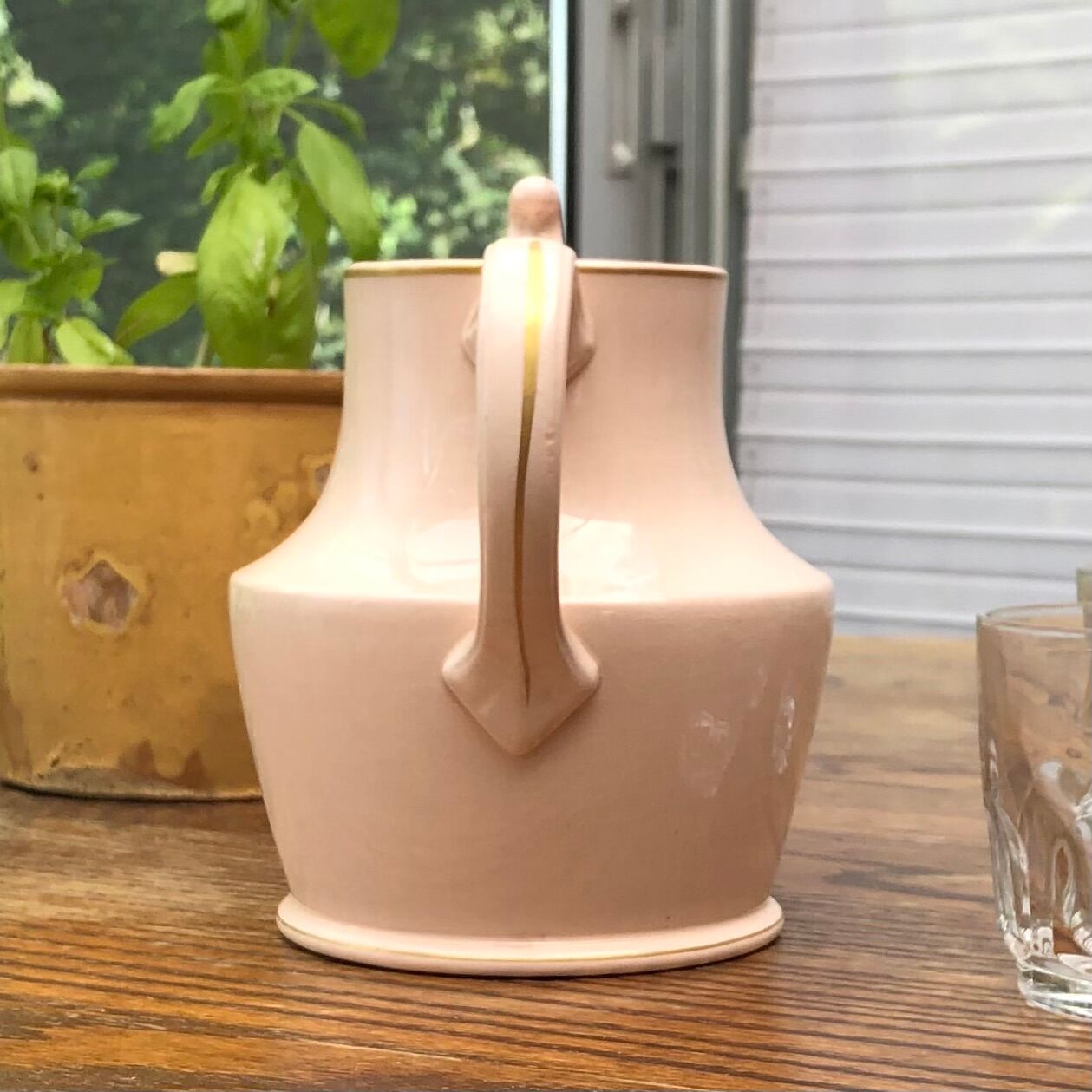 Antique pitcher in pink ceramic