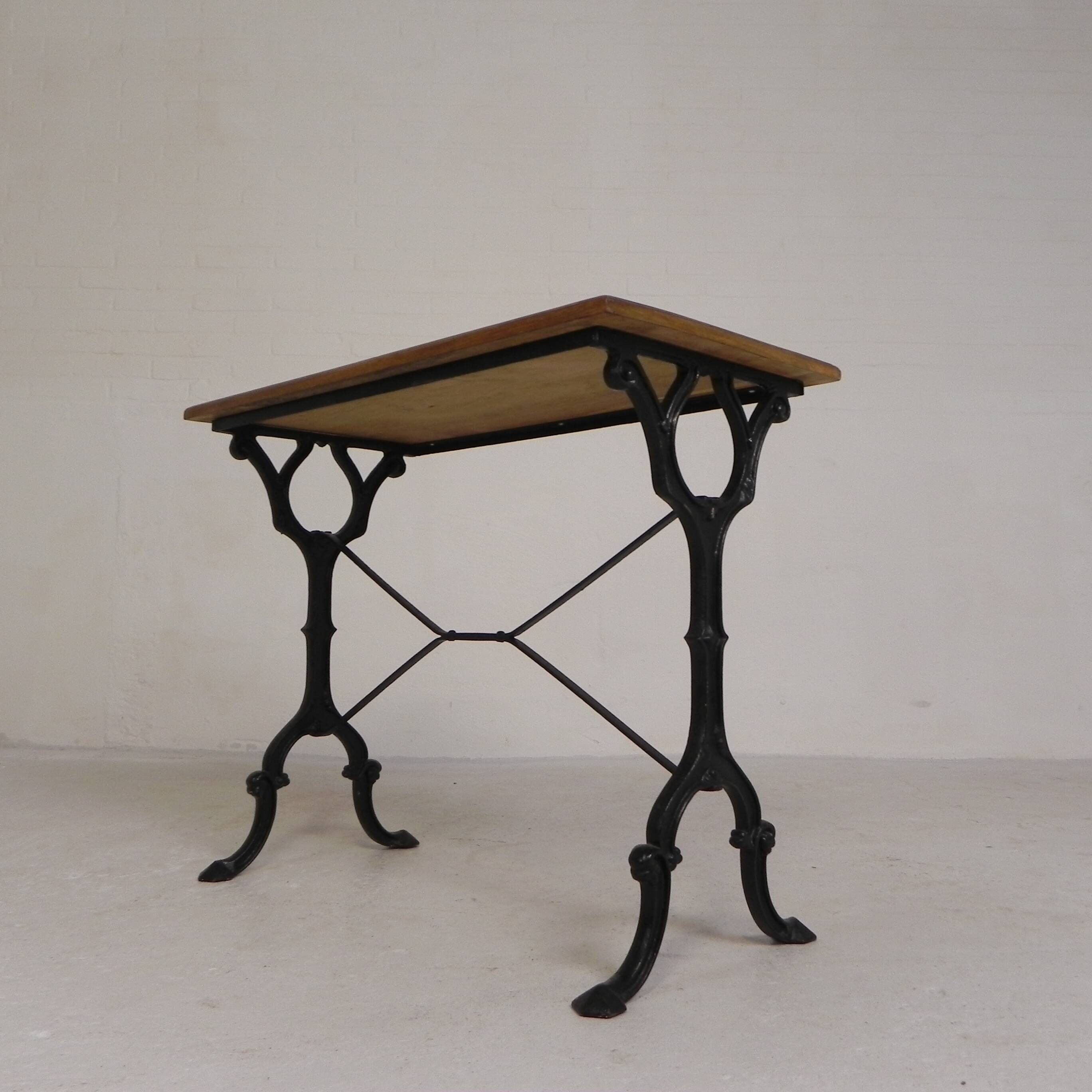 Bistro table with an oak top on a cast iron base, 1930s.