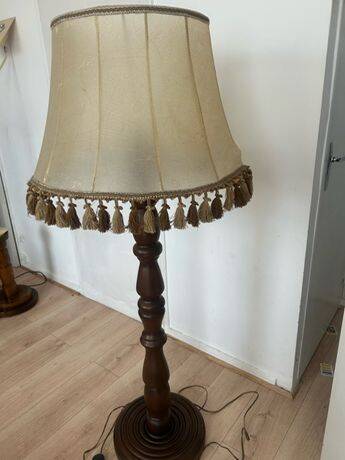 Large vintage wooden floor lamp with parchment shade and pendants.