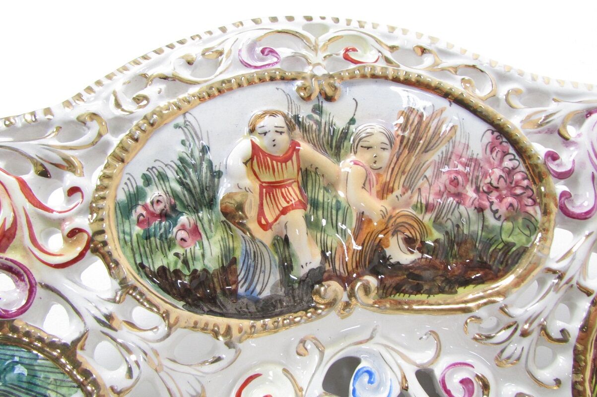 Capedimonté openwork plate, 4 seasons putto
