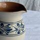 Vintage white pitcher with stylized blue plant frieze H17.5