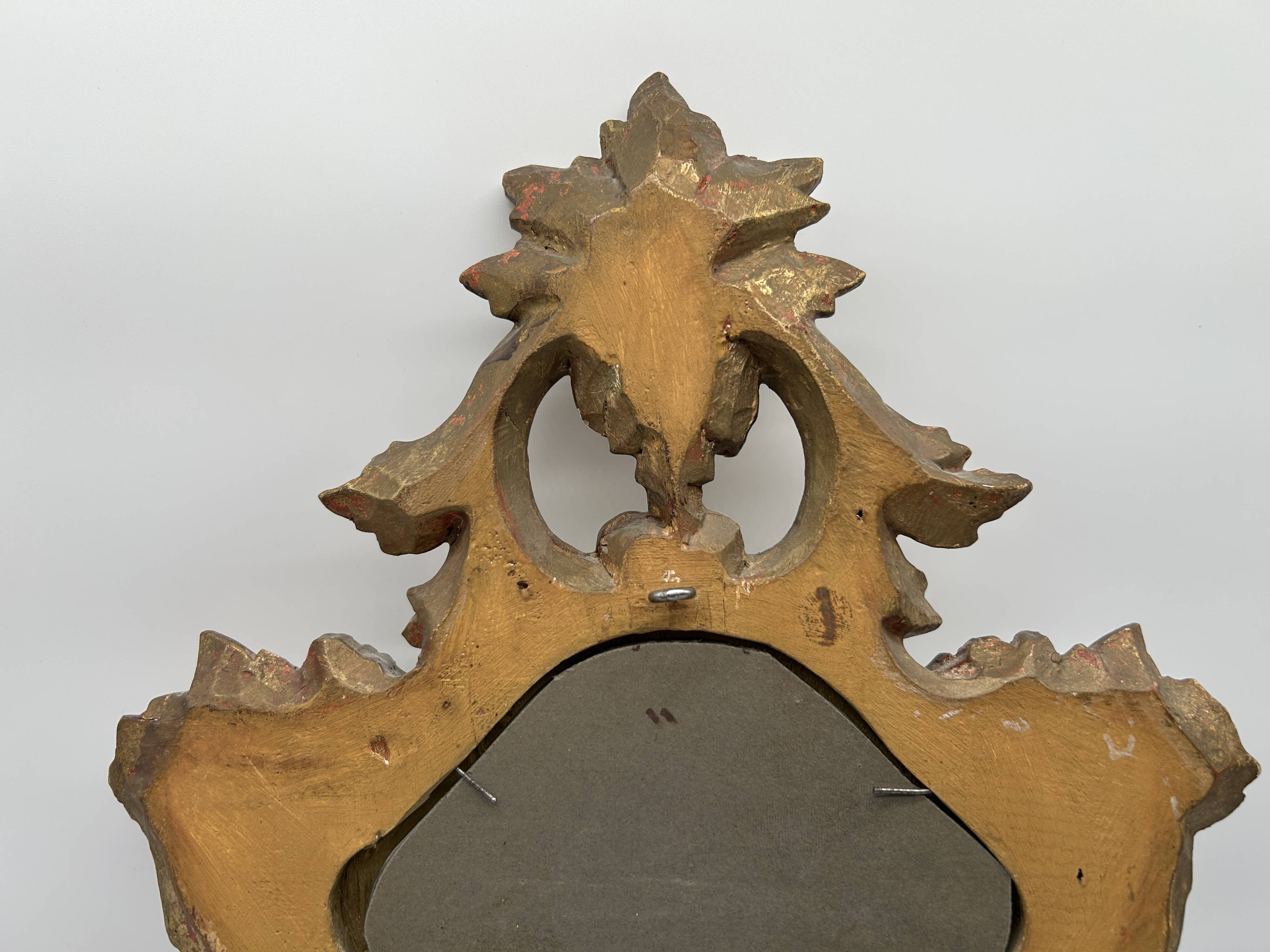 Wooden mirror with gilded stucco