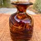 A brown speckled vase with yellow spots pattern is called "scale of".
