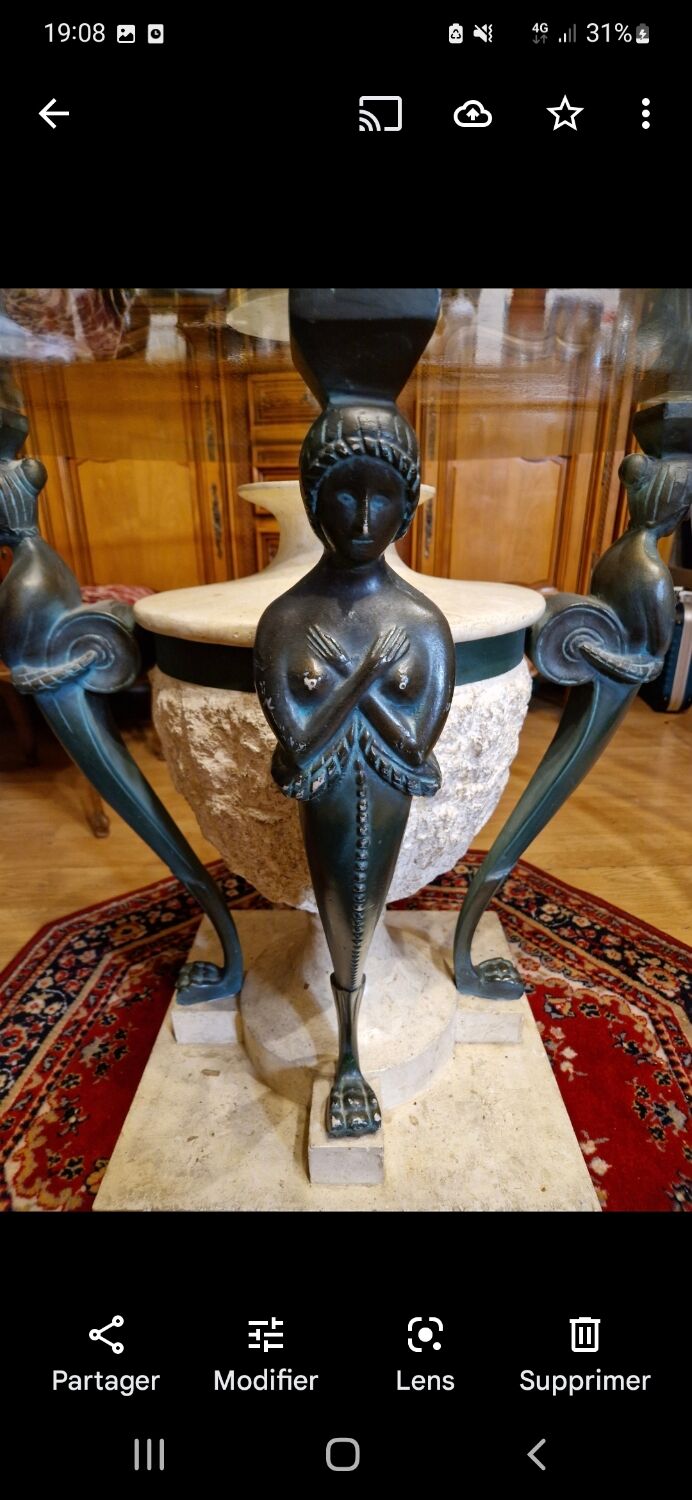 Stone and bronze dining table with ribbed glass top