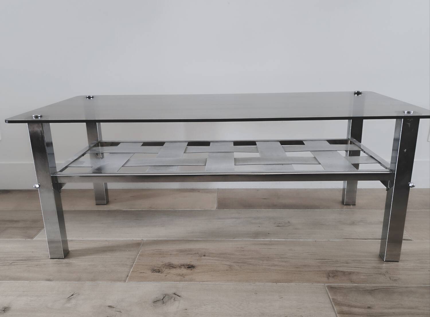 Vintage smoked glass coffee table with chrome legs.