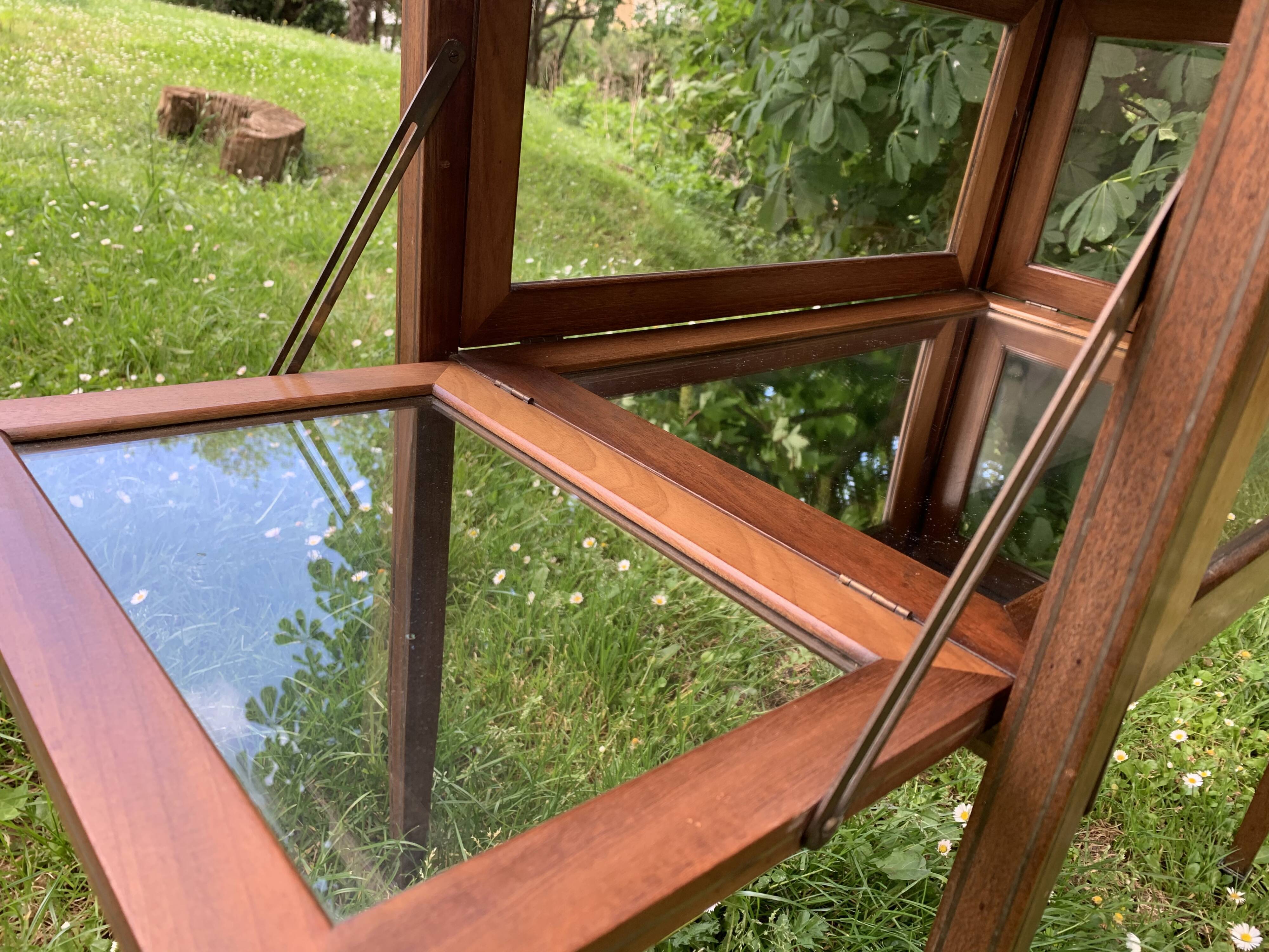 Glass-enclosed old tea table with wooden tray, bronze and brass