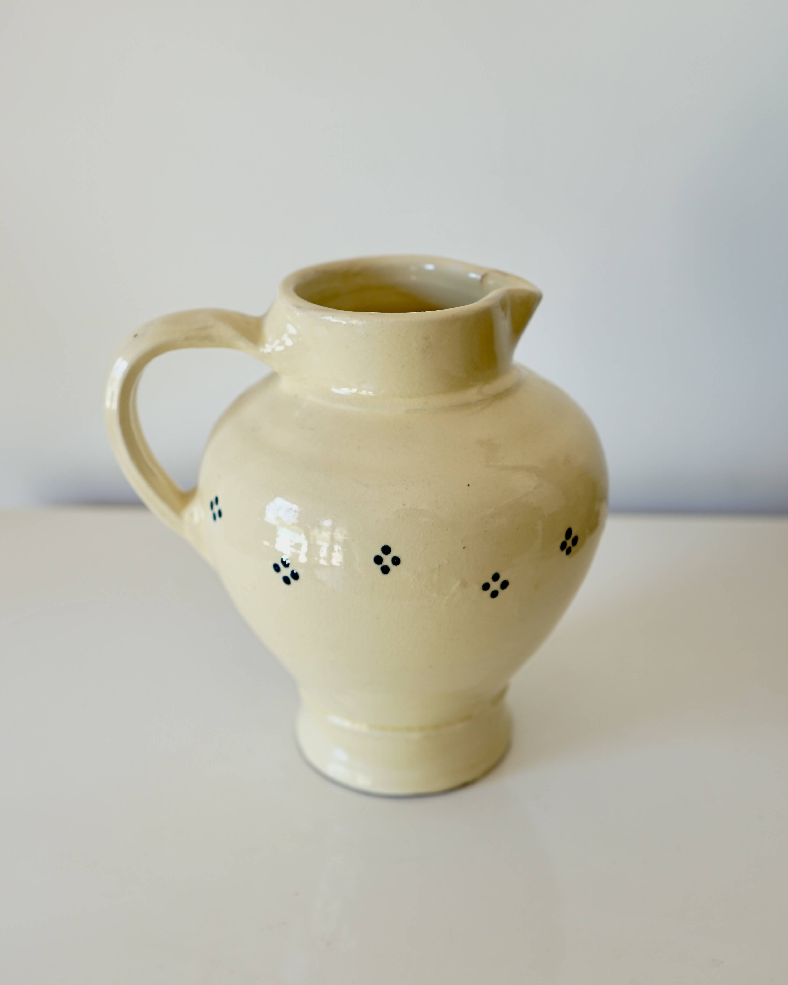 Vintage butter yellow ceramic pitcher in rustic style