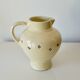 Vintage butter yellow ceramic pitcher in rustic style