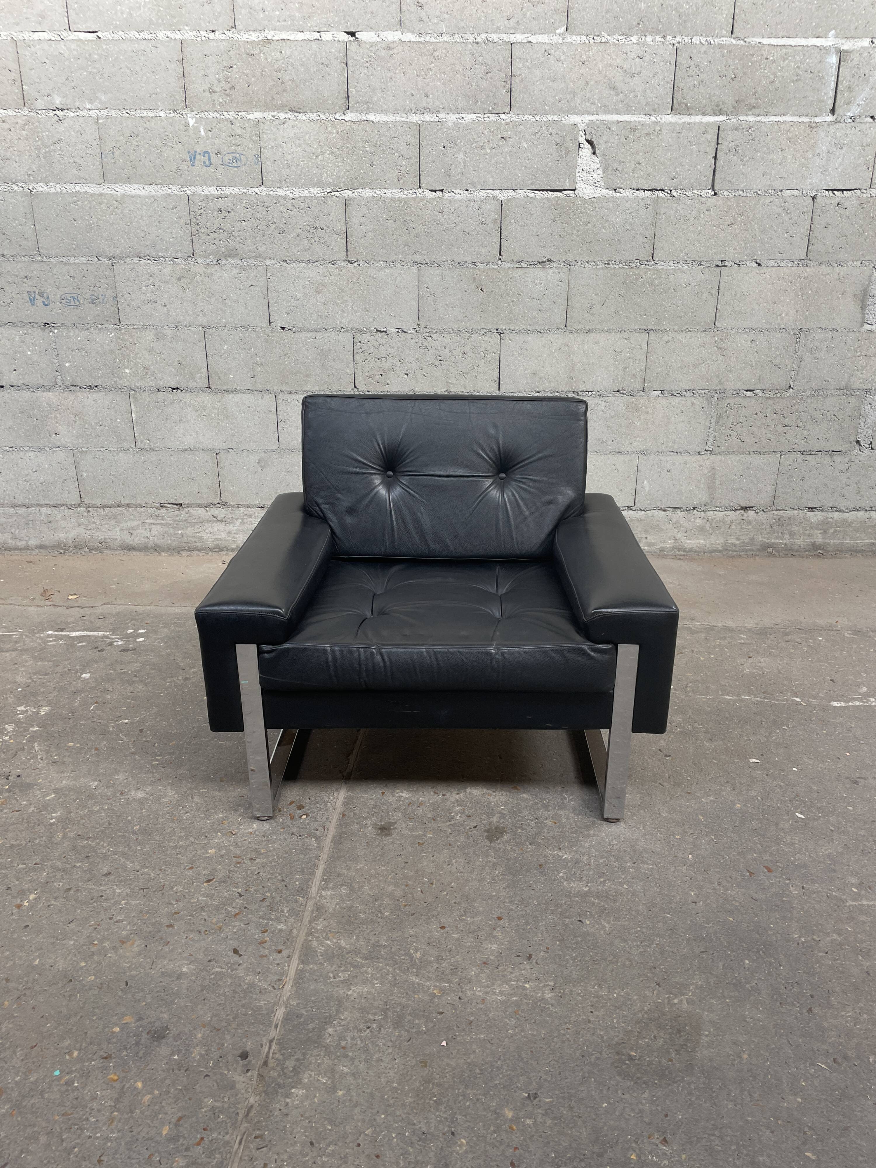 Pair of black leather armchairs
