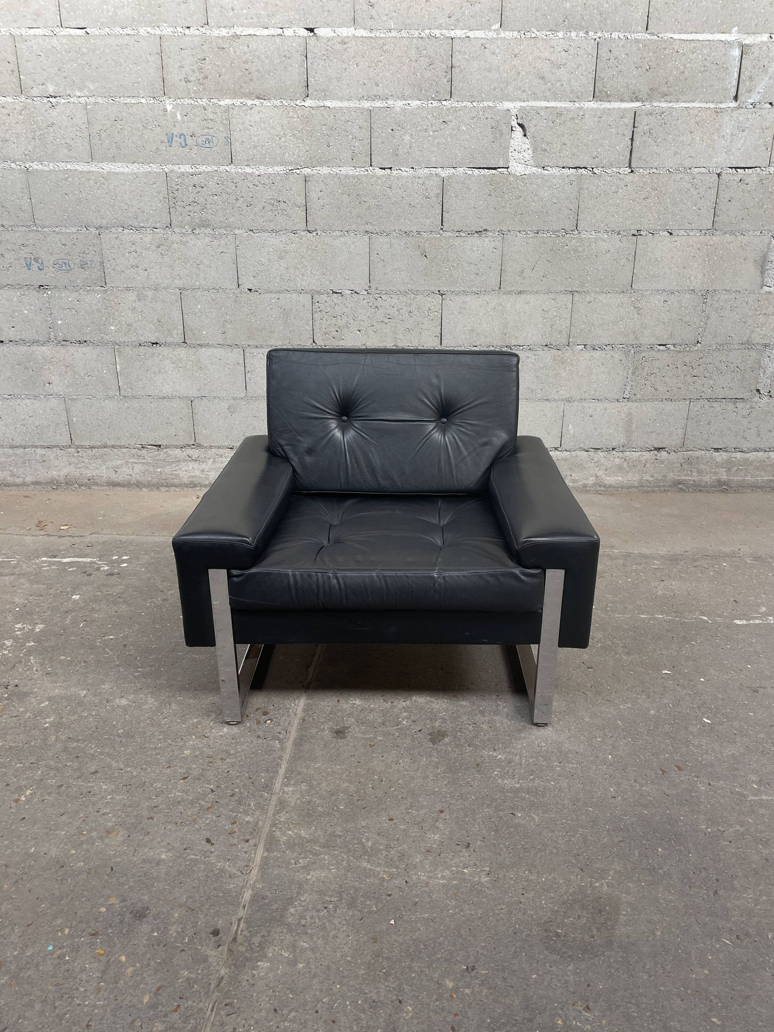 Pair of black leather armchairs