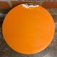 Vintage bistro table with black cast iron base and orange bakelite top, 1950s