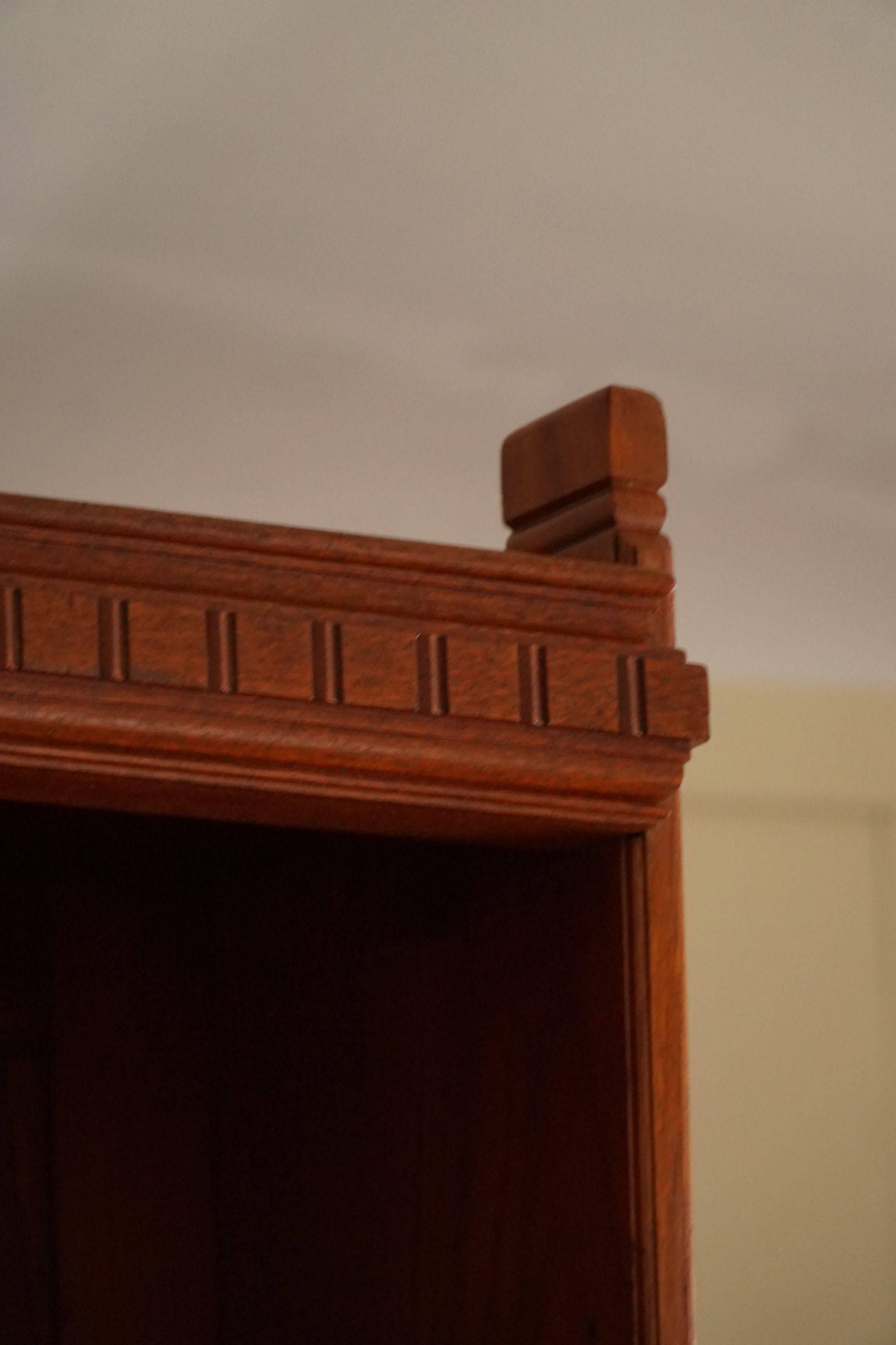 Rare high cabinet in teak by Martin Nyrop for Rud. Rasmussen, Denmark, early 20th century.