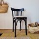 Curved black wooden bistro chair with striped seat
