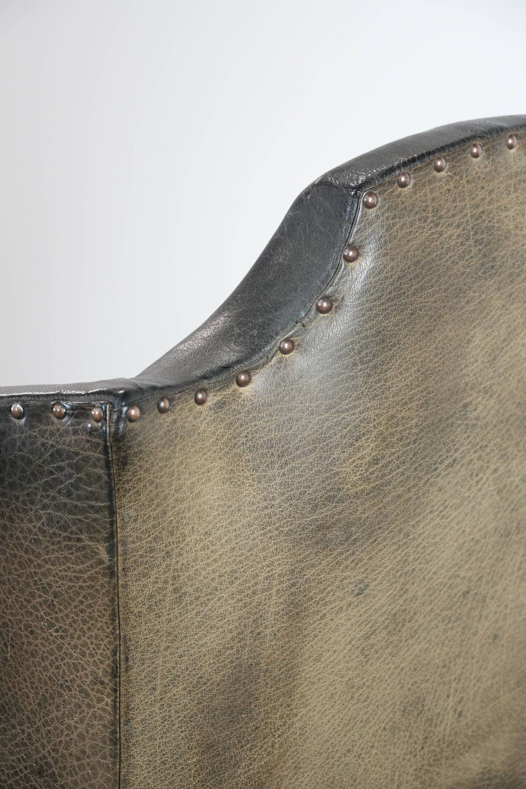 Antique black English cow leather wingback armchair from the 19th century