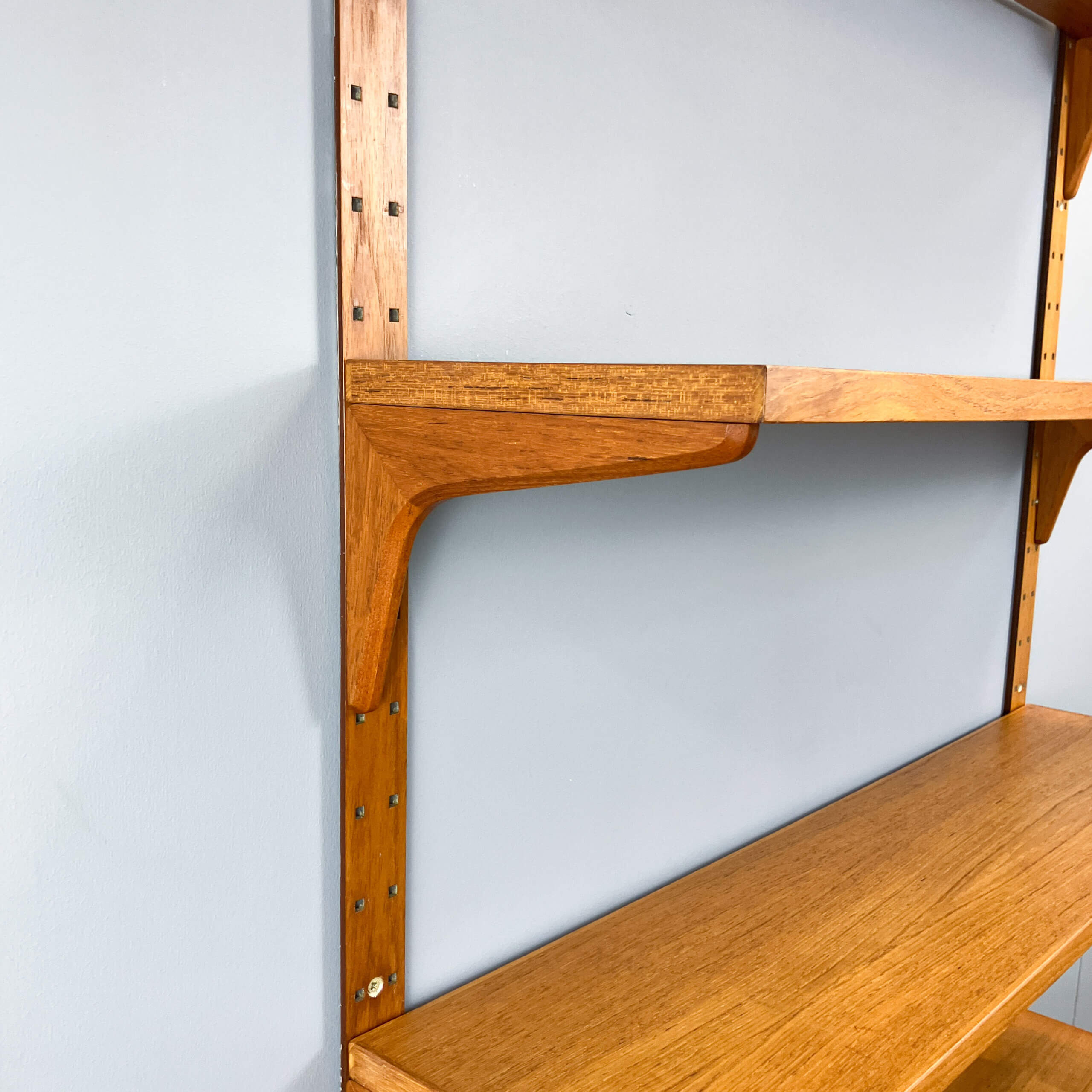 Danish wall shelf by Hansen and Guldborg, teak, aluminum rails, 1960s.