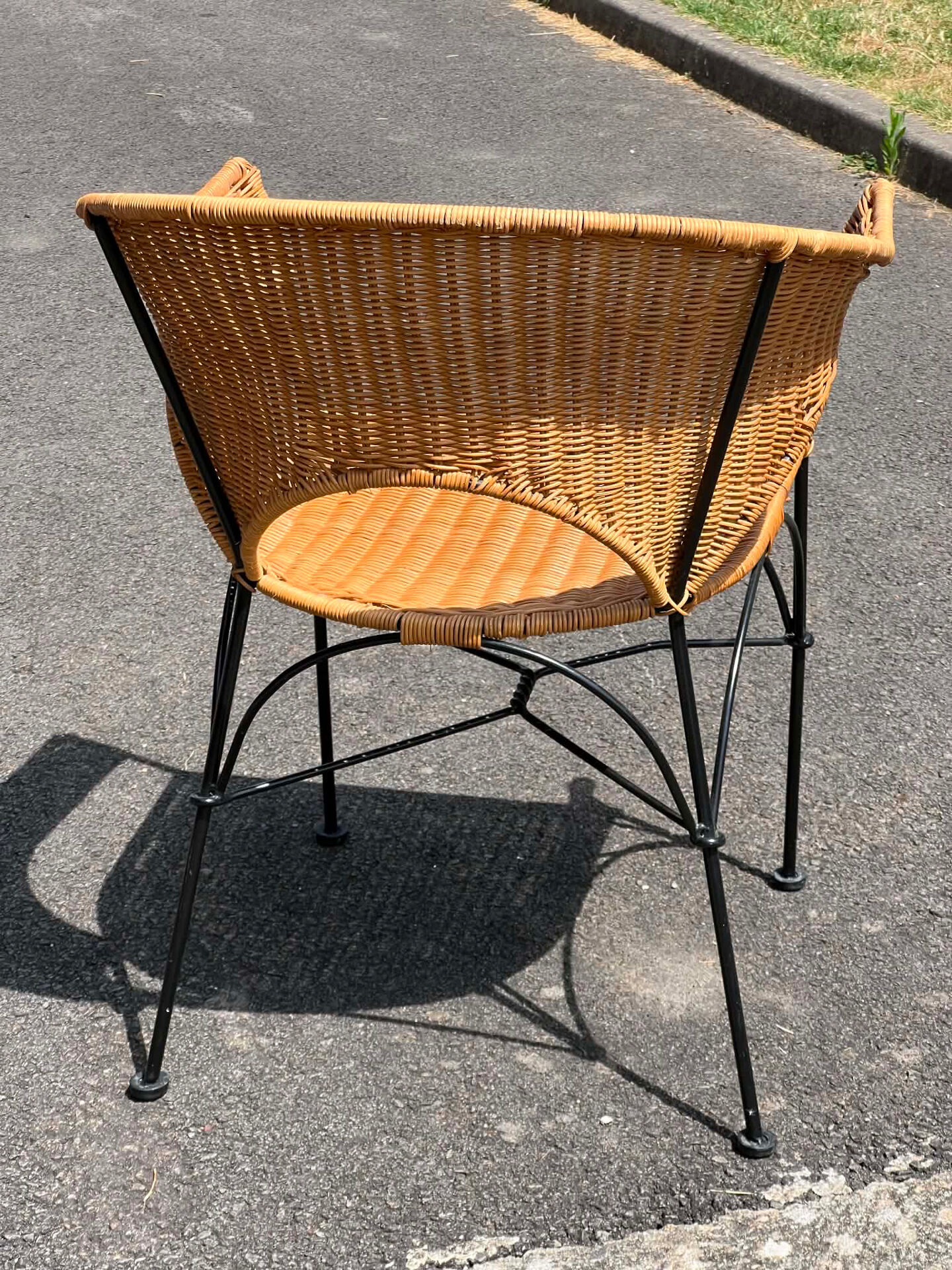 Wicker and black wrought iron armchair