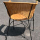 Wicker and black wrought iron armchair