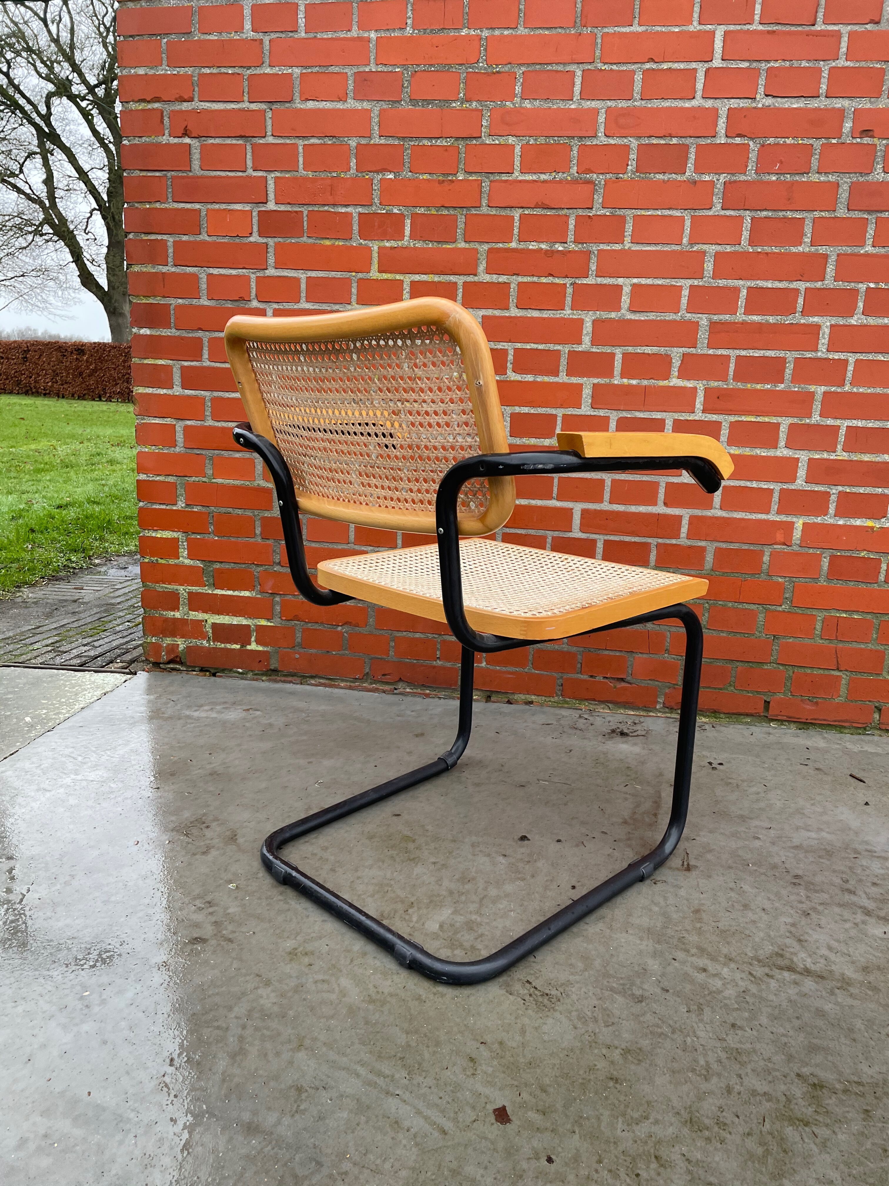Cesca model chair designed by Marcel Breuer with black-framed armrests