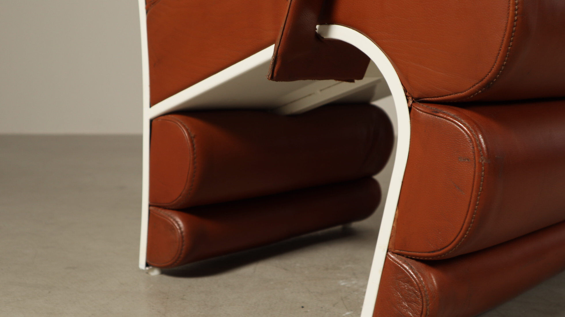 Pair of sculptural cognac leather armchairs, 1970s