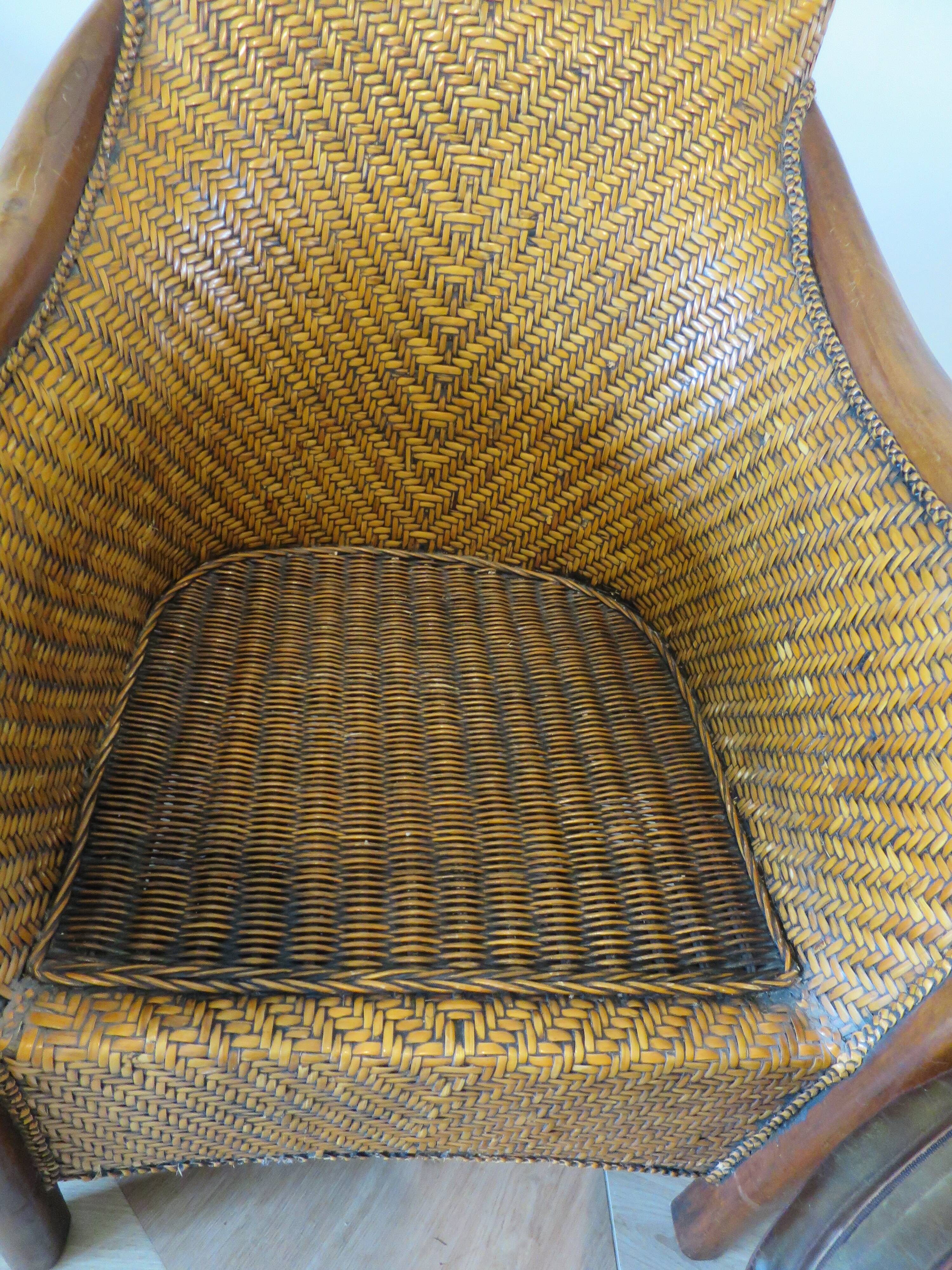 Colonial style armchair in woven rattan and exotic wood