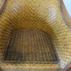 Colonial style armchair in woven rattan and exotic wood