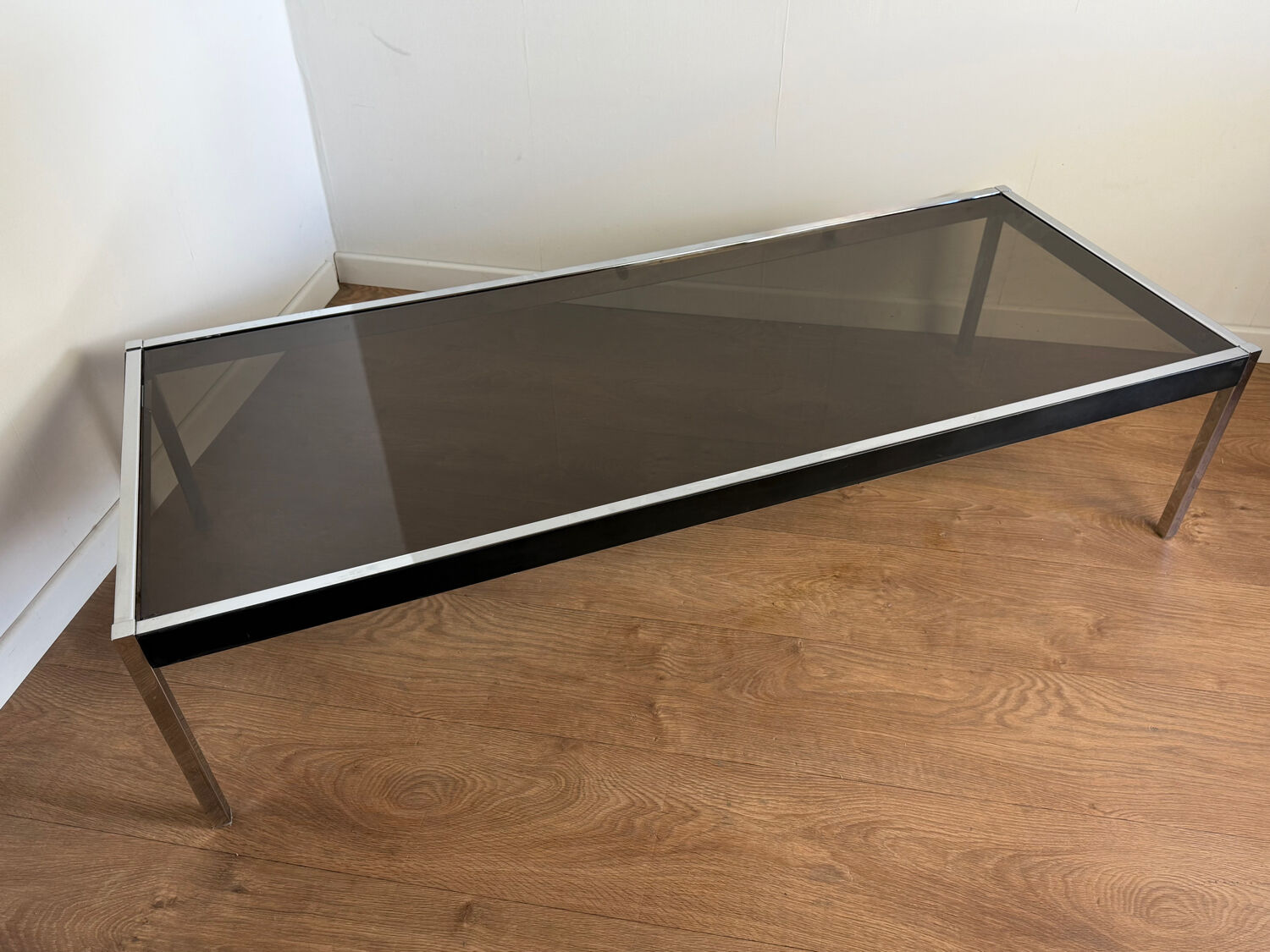 Large designer coffee table from the 70s in chrome, smoked glass, and faux leather.