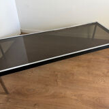 Large designer coffee table from the 70s in chrome, smoked glass, and faux leather.