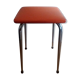 Tabouret orange pieds compas