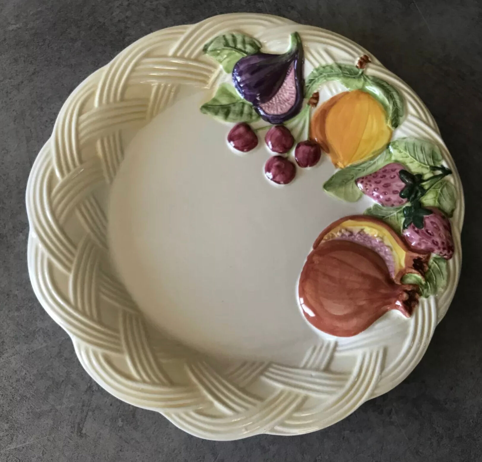 Vintage plate in ceramic enamelled decoration of fruits in relief
