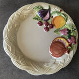 Vintage plate in ceramic enamelled decoration of fruits in relief