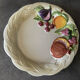 Vintage plate in ceramic enamelled decoration of fruits in relief