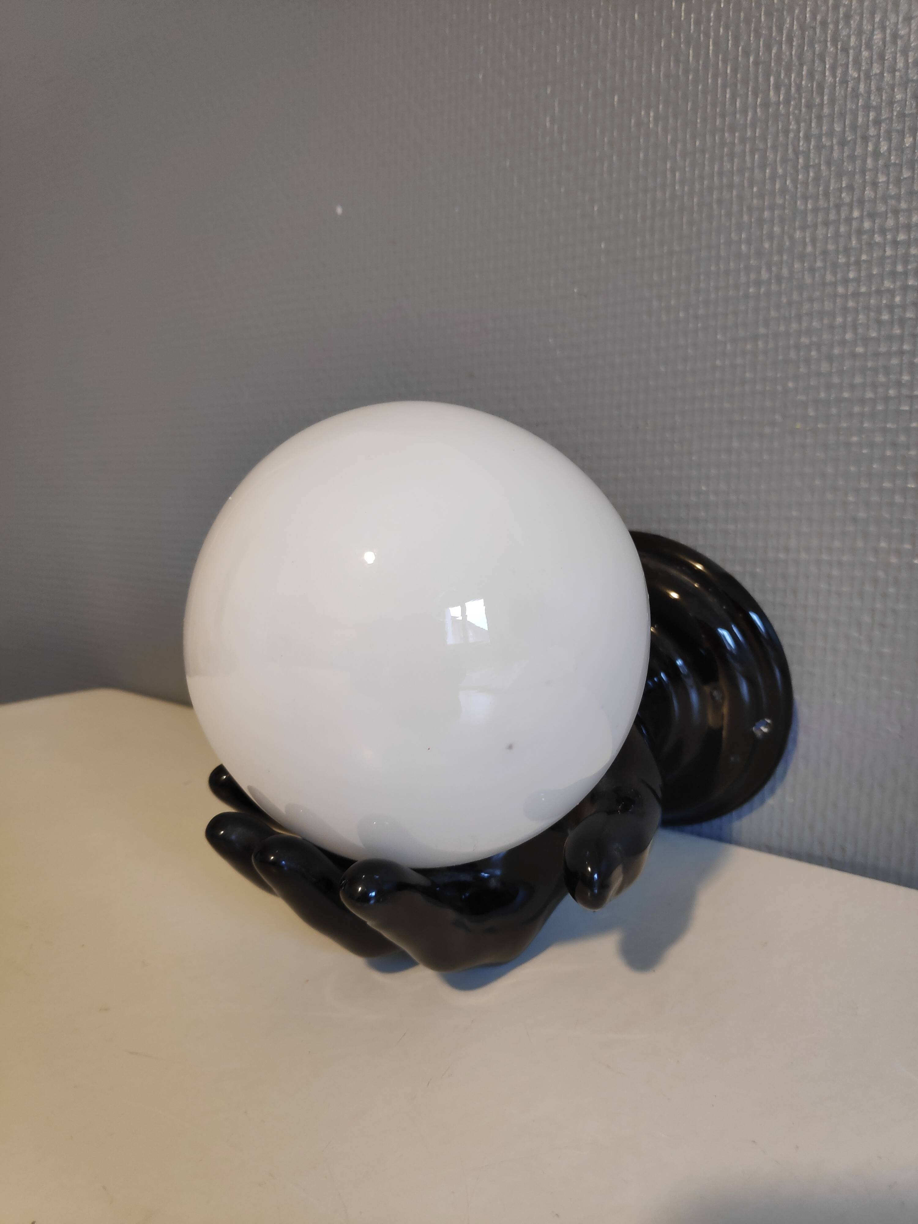 Black ceramic handand white opaline ball sconce