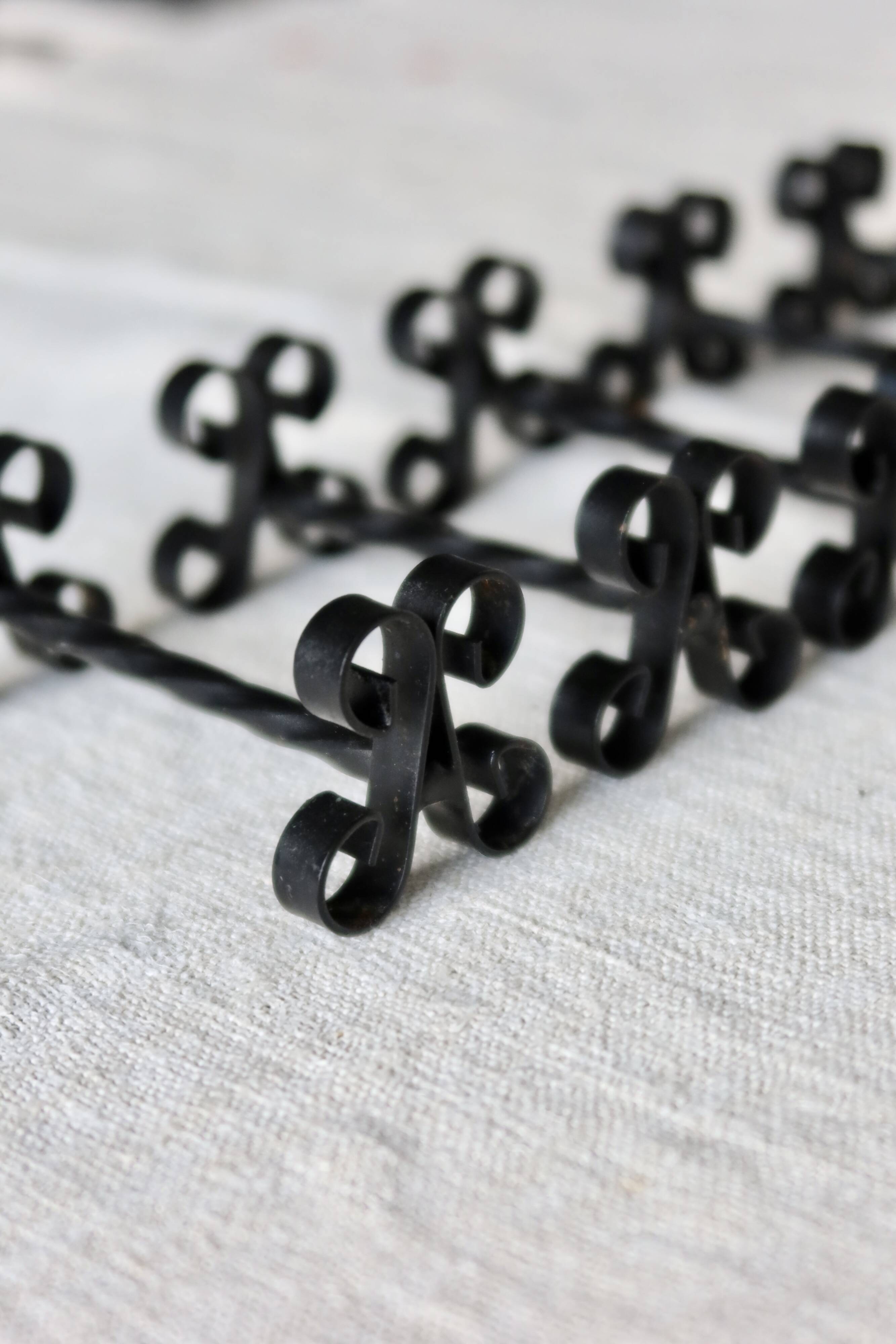 6 vintage black metal knife rests with scrollwork decoration