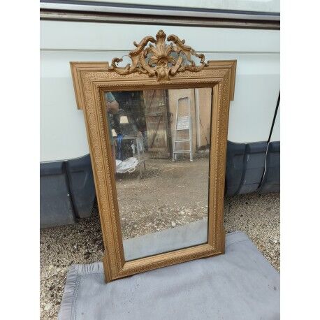 19th-century mirror in gilded wood and stucco.