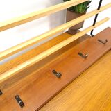 Vintage wall coat rack with black hooks and light wood