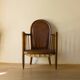 Antique armchair in solid wood and patinated brown leather, early 20th century.