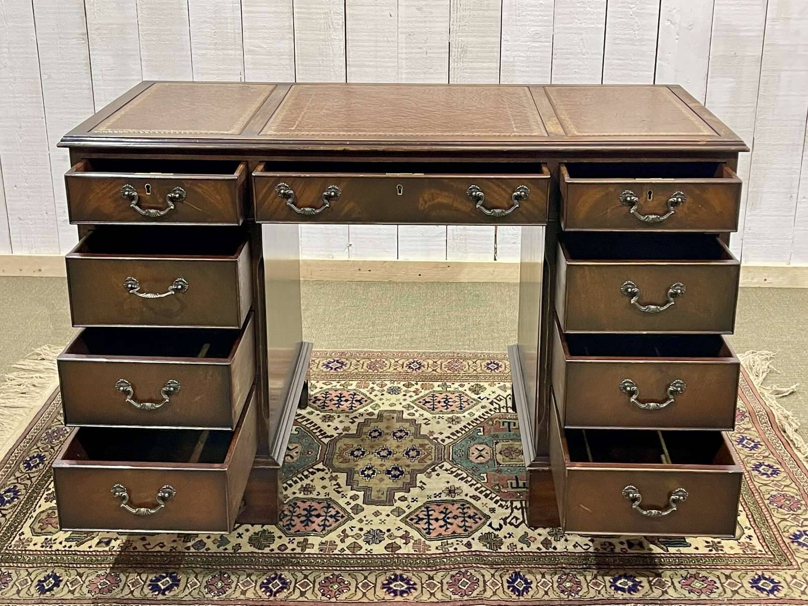 English mahogany pedestal desk with leather top from the 1950s