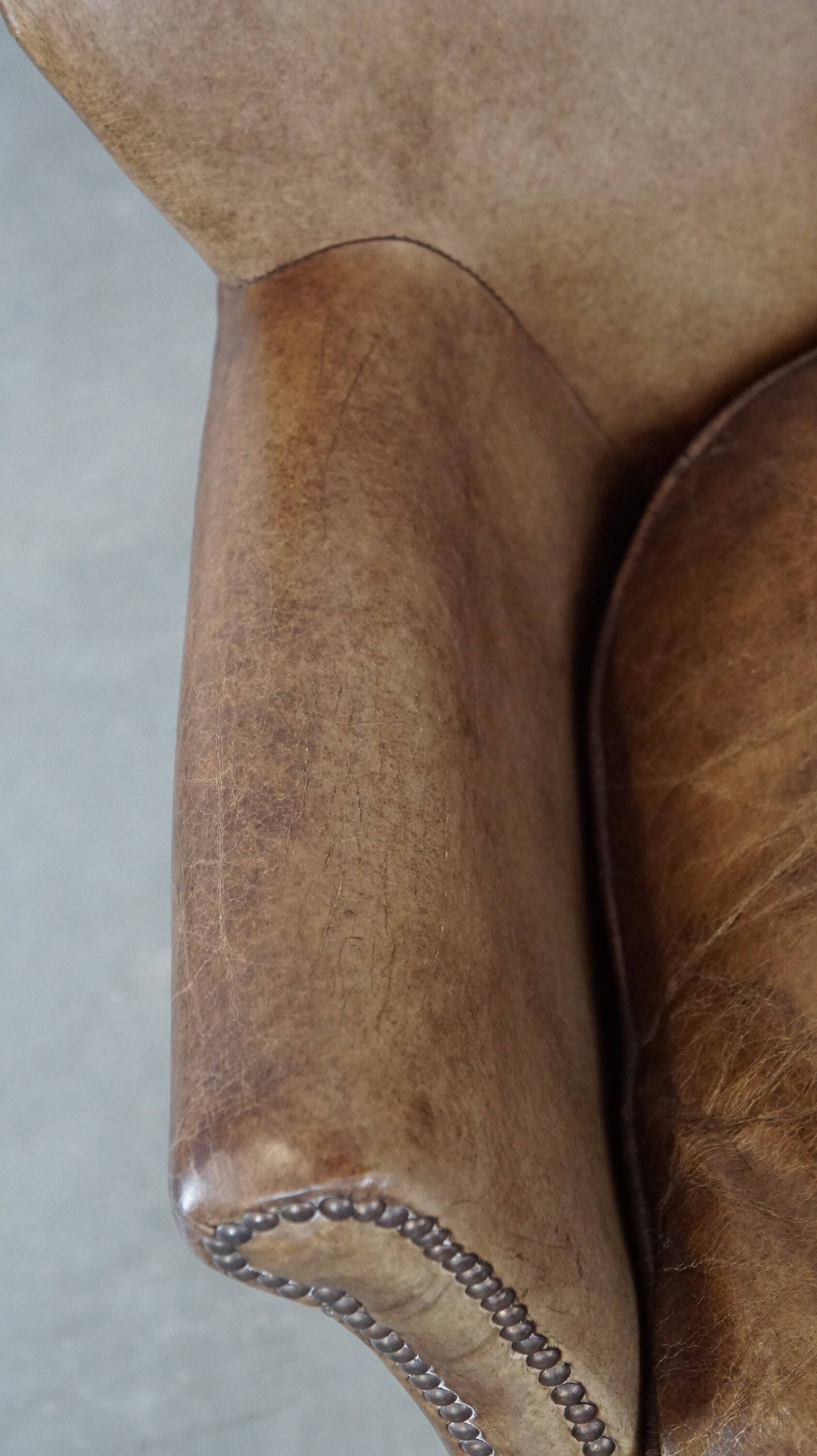 Subtle leather armchair with a reversible kilim seat cushion