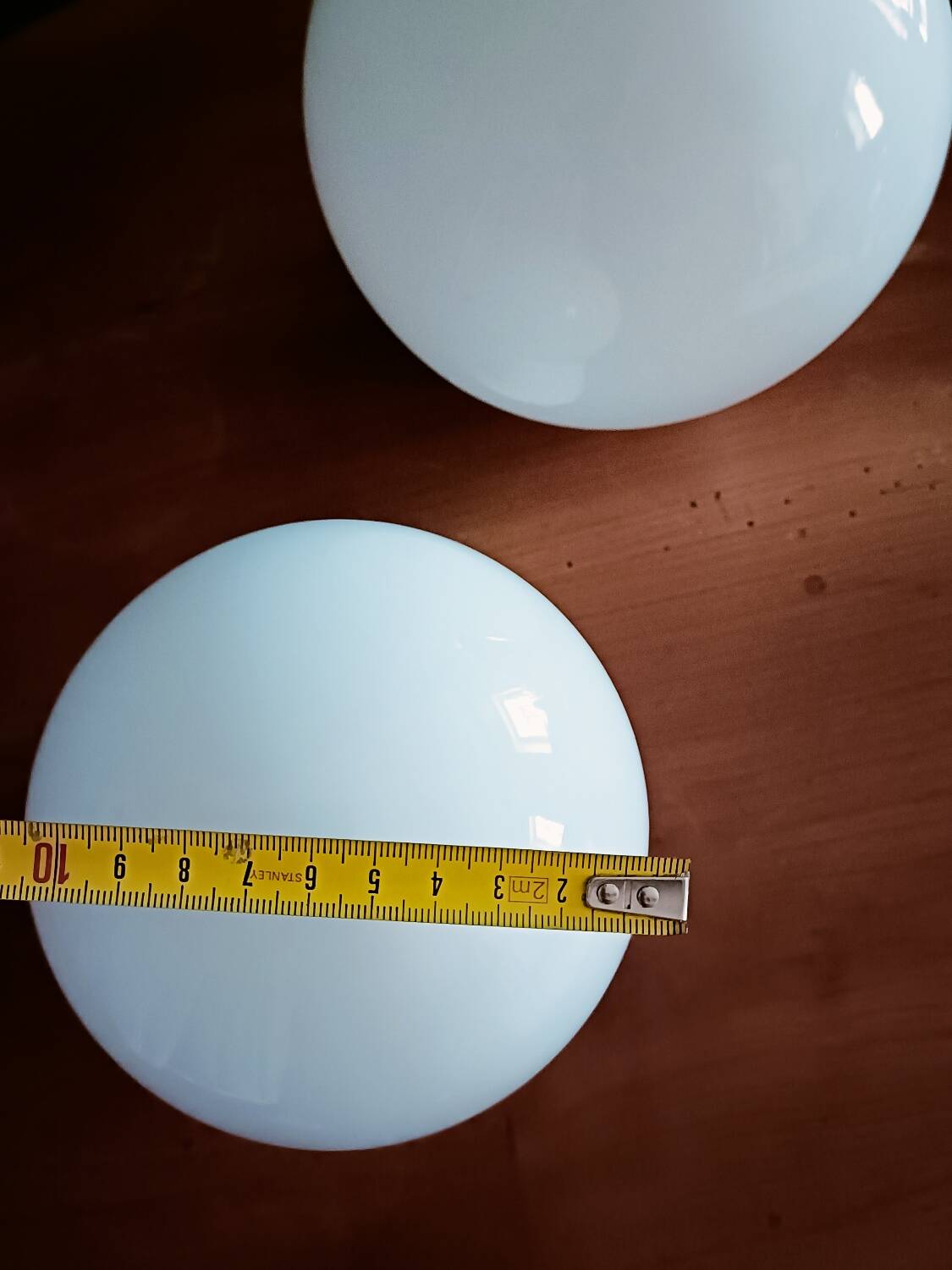 Two opaline glass globe wall lights
