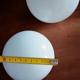 Two opaline glass globe wall lights