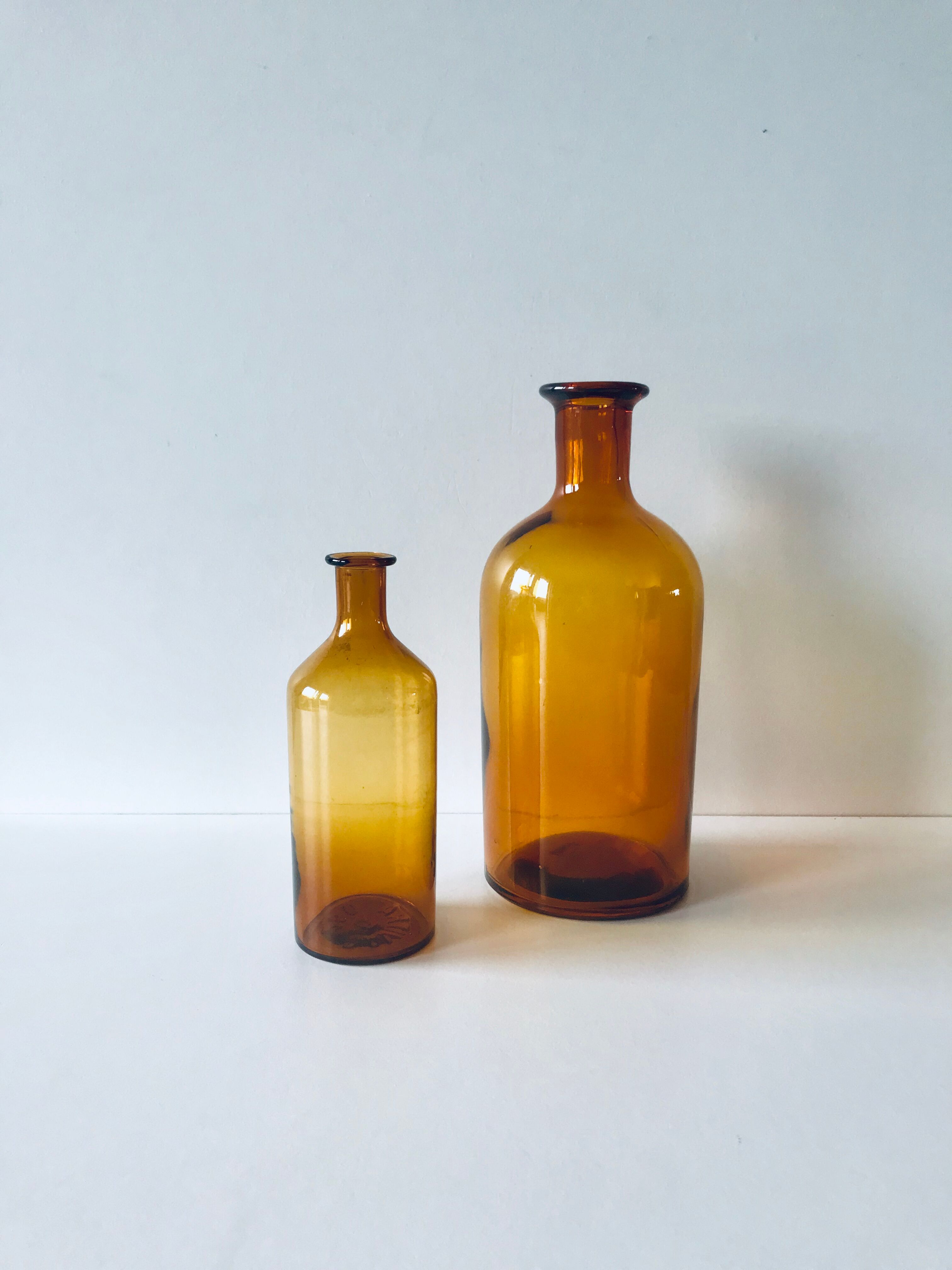 Duo of ancient apothecary flakes in amber glass