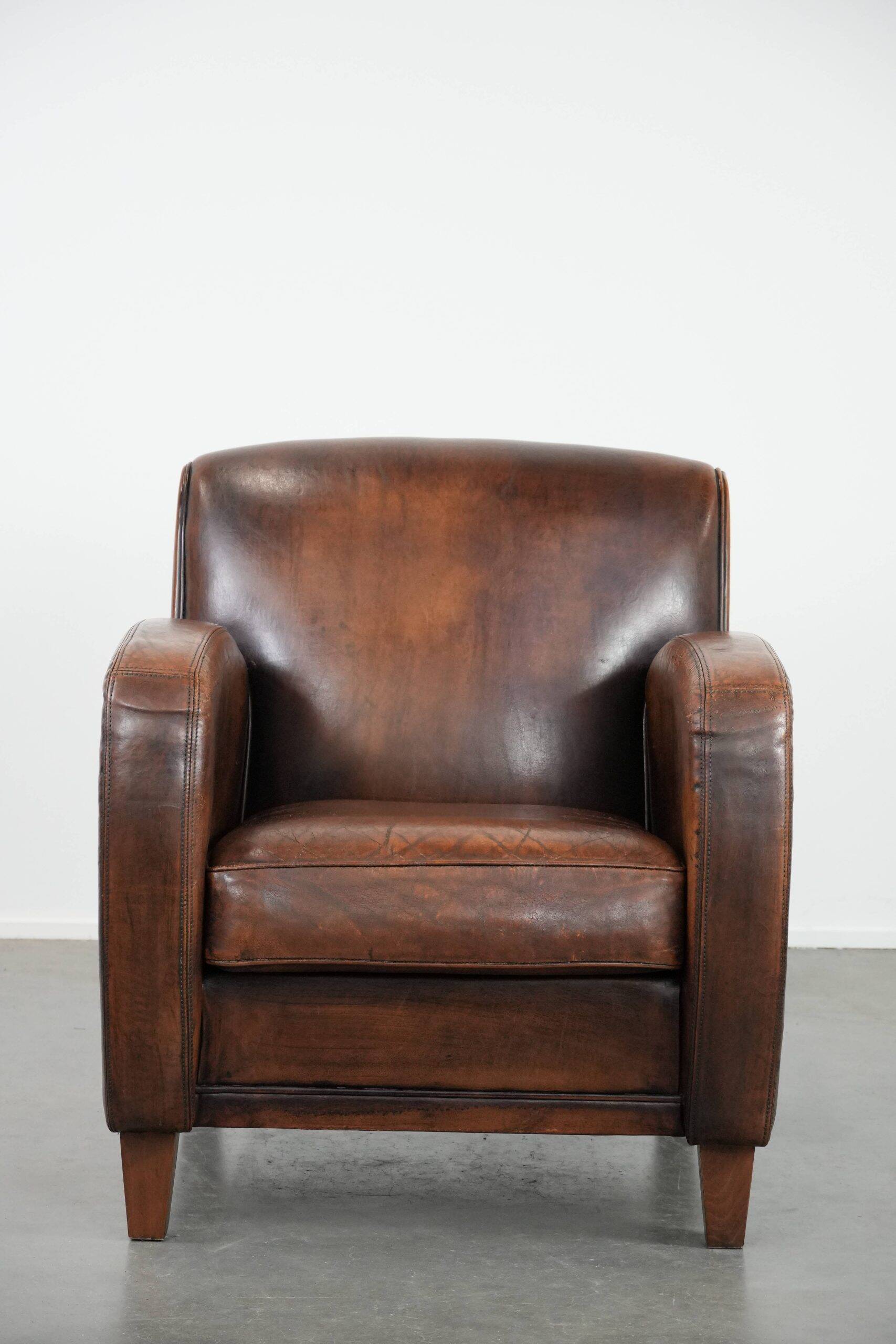 Beautifully shaped vintage sheepskin armchair with character